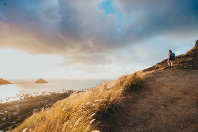 Hawaii elopement photographer watches the sunrise from the Lanikai Pillbox trail on Oahu, Hawaii