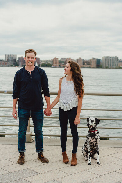 couple with dog by the water in new york