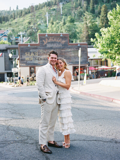 couple in the streets of downtown park city at their rehearsal dinner