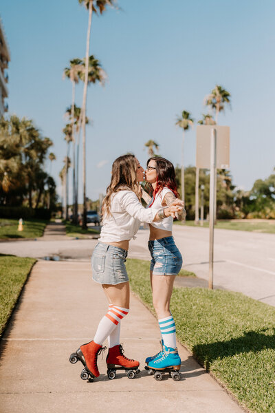 two women wearing roller skates while kissing