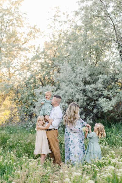 family playing in a utah meadow