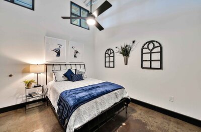Vintage industrial master bedroom in this one-bedroom, one-bathroom luxury rental condo in the historic Behrens building in downtown Waco within walking distance to the Silos, Baylor, and local museums.