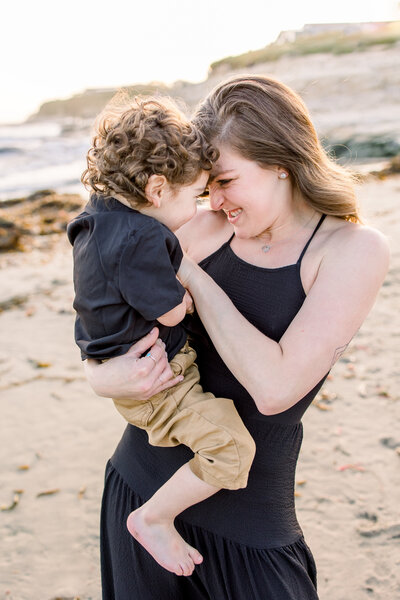 A mother snuggles her son during their family photos at Shaver Lake