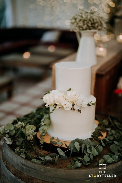 Elegant white wedding cake with fresh flowers
