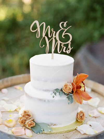 wedding cake with a mrs and mr sign on top