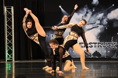 acro dancers doing a pose together on stage at thunderstruck