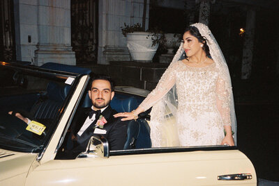 Bride and groom with classic car at wedding, Rosecliff Mansion in Newport