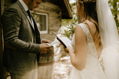 A couple reading their wedding vows to each other