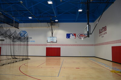 Gymnasium with blue ceiling and baseball wall accents