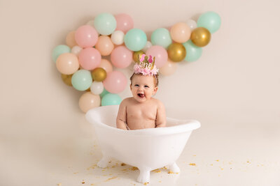 baby wearing crown in tub by Philadelphia Newborn Photographer