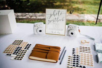 Table with materisl for photo guestbook, Blended wedding at Peirce Farm at Witch Hill