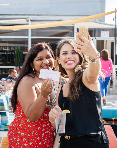 Women taking a selfie at a corporate event