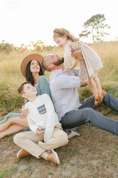 Family in a field playing and laughing, by new jersey family photographer