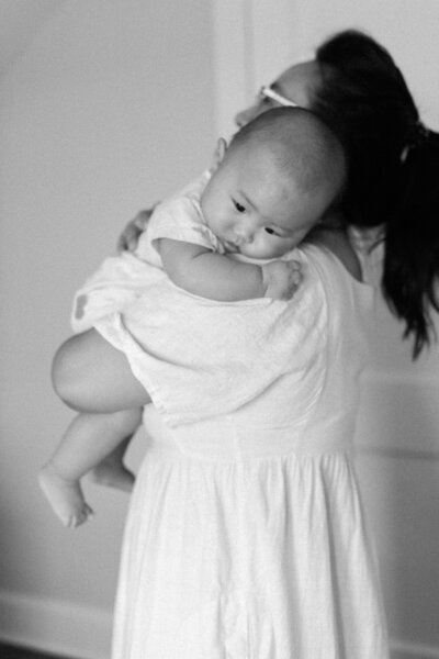 black and white of mom holding baby boy