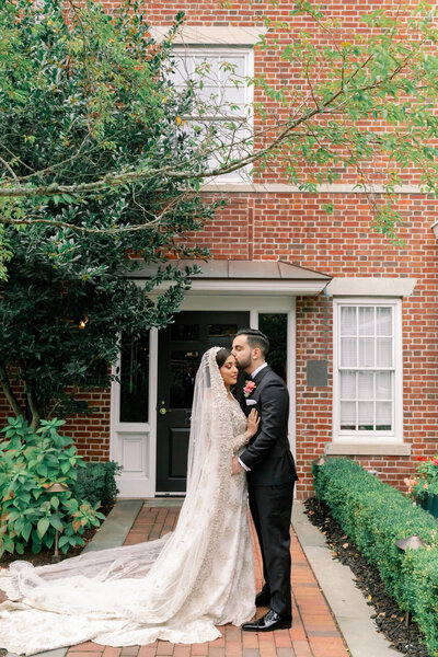 Couple standing together on wedding day holding each other, Rosecliff Mansion Wedding, Unique Melody Events & Design (New England Wedding Planners)