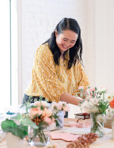 Asian Wedding Planner prepping flowers and cake