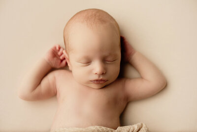 Artistic childrens portrait of baby wearing sleep hat