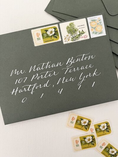 Sage green save the date envelope with white ink calligraphy ink  calligraphy and vintage postage stamps
