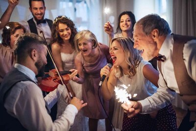 Wedding guests singing along with band at reception