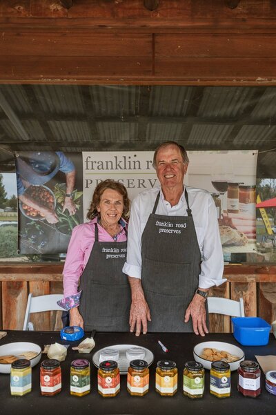 Franklin Road Preserves stallholders offering samples at a local community event.