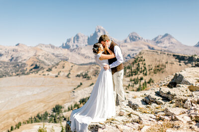 Couple on Fred Mountain in Wedding Dress with Tetons in the Background