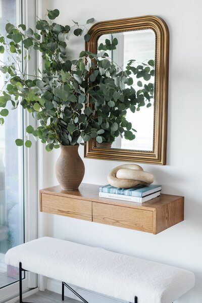 Entryway With Wooden Floating Shelf and Neutral Decor