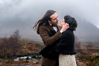 couple embrace during winter glencoe elopement