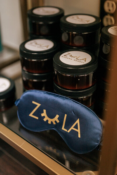 Zula Modern Medspa eye mask sitting next to containers of skincare products