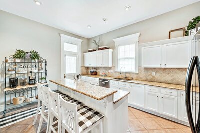 Remodeled kitchen with large island and ample seating in historic vacation rental home in downtown Waco, TX