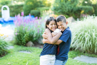 kids hugging  and smiling in the garden