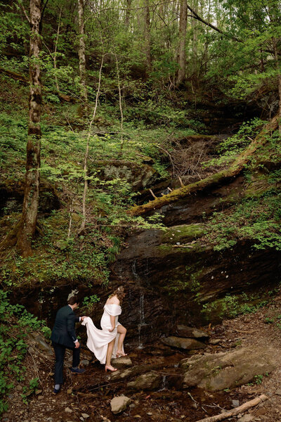 candid wedding photo by gatlinburg photographers of couple hiking in the Smoky Mountains 