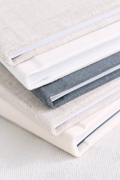 stack of linen-covered photography albums
