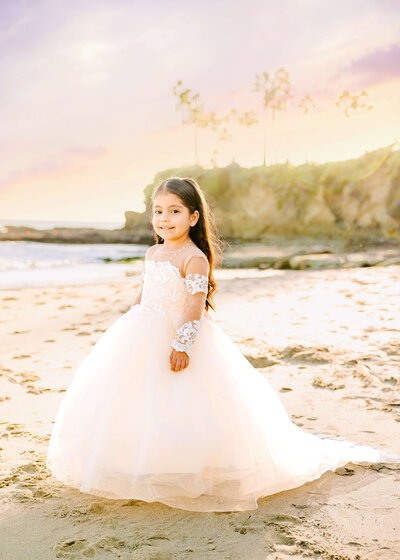Little girl posed at Laguna Beach for birthday photoshoot by Ashley Nicole Photography