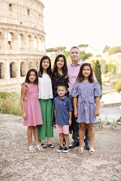 Family of six with the Colosseum in the background. Taken by Rome Family Photographer, Tricia Anne Photography