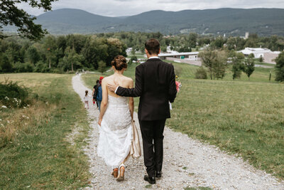 Bride and Groom walking on path together, UME (New England Wedding Planners) helped with planning