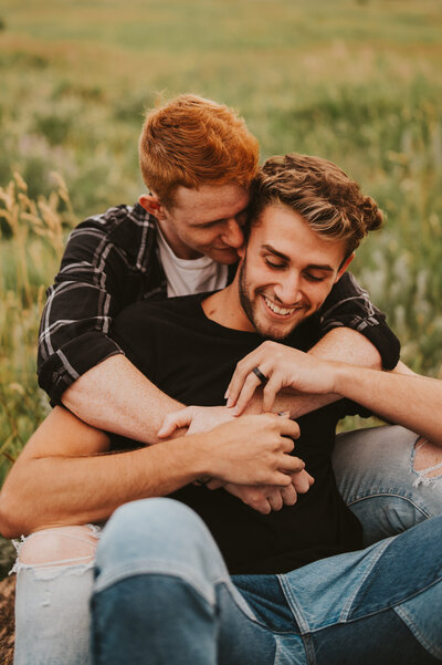 couple embracing in a grass field