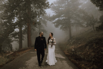 sunrise amphitheater elopement couple walking in fog