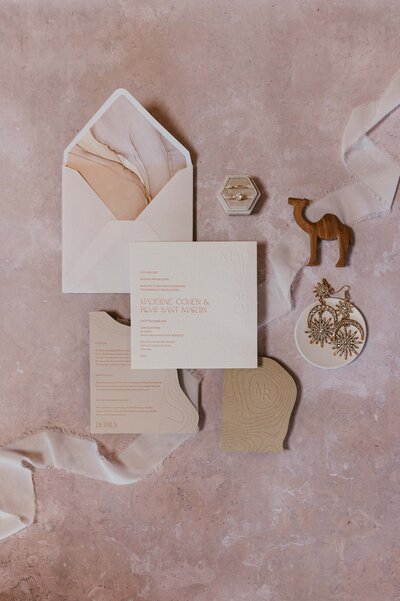 Wedding flat lay with camels and stationary by Ink and Paper London.