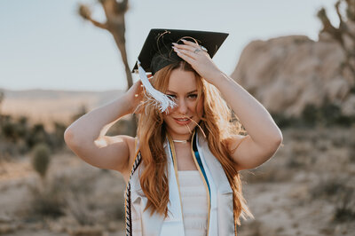 a graduating student taking photos in joshua tree with her photographer