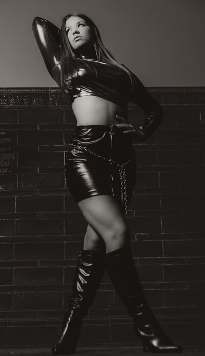 Moody black-and-white senior portrait with cinematic lighting setup by Lansing senior photographer.

