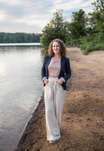 A woman poses during her personal branding photoshoot in a blazer in Baltimore, Maryland near Towson, Maryland.