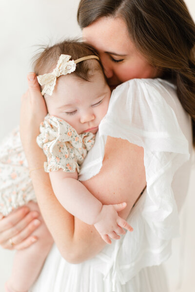 A northern va newborn photography photo of a baby asleep snuggled up in her mama's arms