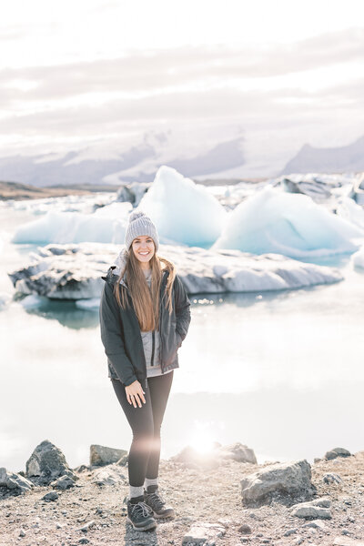 Portrait of a woman photographer, Nicole, smiling at Glacier Lagoon in Iceland during an elopement.