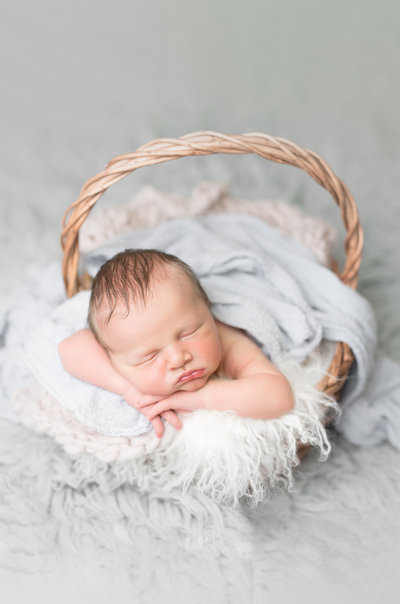 Newborn boy in a basket