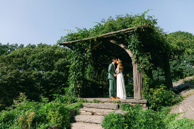 A couple kiss after their wedding ceremony at the Dene Shelter in Central Park