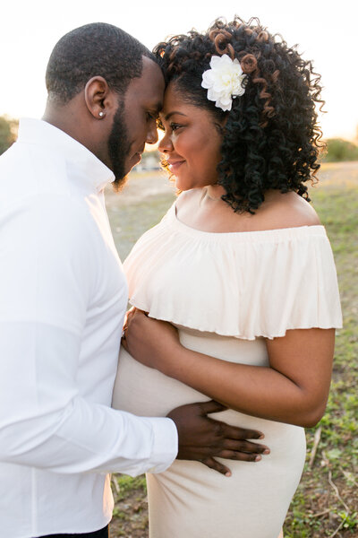 atlanta maternity photographer - roswell maternity photoshoot - expecting mom and dad in field, maternity dress