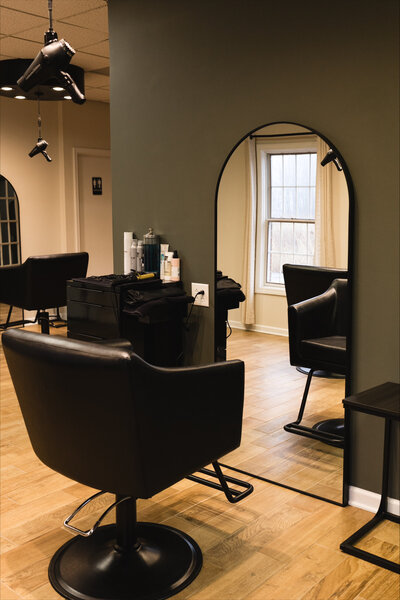 Salon chair and arched mirror at Raw Beauty Bar