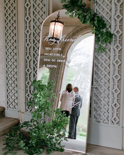 Arched gold mirror sign with calligraphy for wedding at The Glen Manor House in Rhode Island
