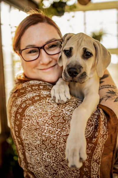 girl holding a black mouth cur