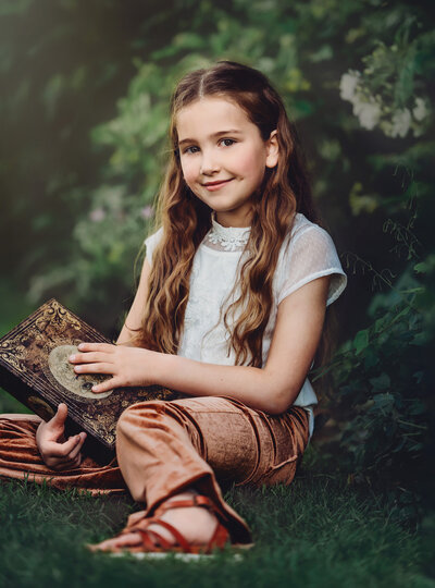 Young girl poses for photo outside in nature